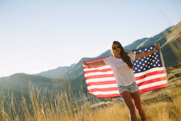 istock Young Woman with American Flag 917877770
