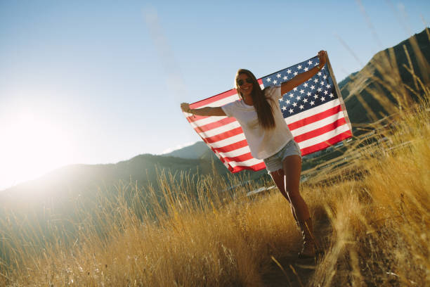 istock Young Woman with American Flag 917877818