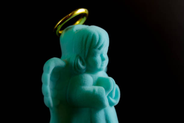 Soft angel toy on a black background 2018