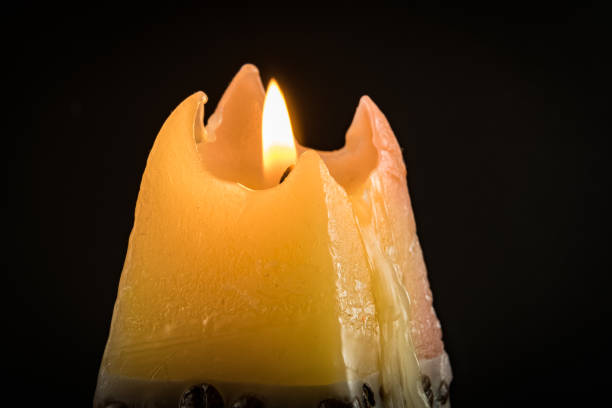 istock One candle flame at night closeup - isolated, macro. 917877864