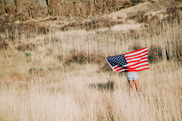 istock Young Woman with American Flag 917878030