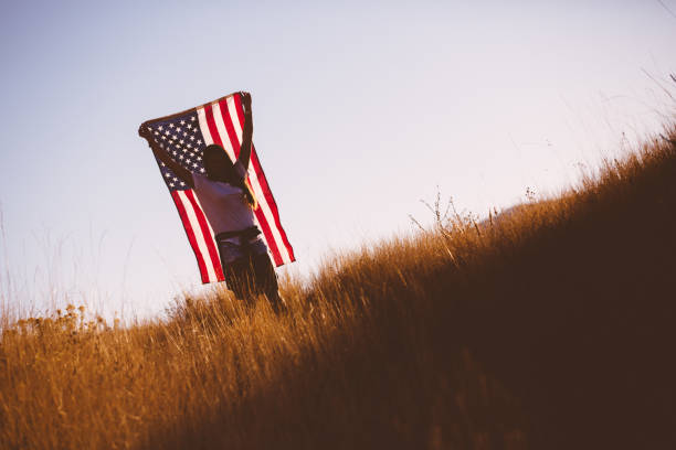 istock Young Woman with American Flag 917878210