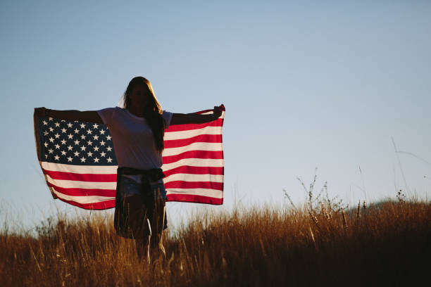 istock Young Woman with American Flag 917878308
