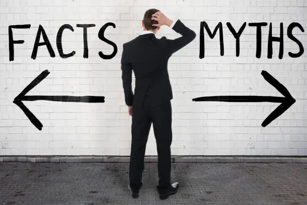 Photo of Businessman Looking At Arrow Signs Below Facts And Myths