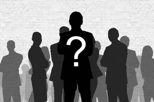 Question mark on silhouette businessman standing in front of colleagues against wall