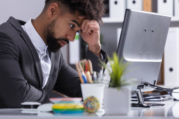 istock Stressed Businessman Sitting In Office 917884946