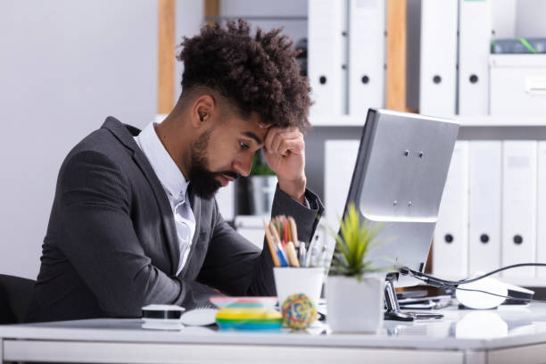istock Stressed Businessman Sitting In Office 917884952