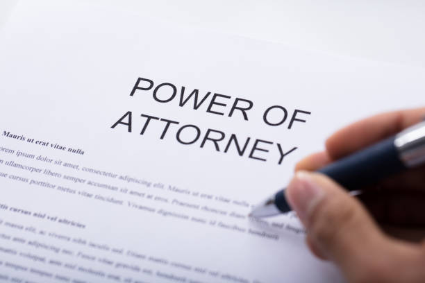 Person Filling Power Of Attorney Form Close-up Of A Person's Hand Filling Power Of Attorney Form beatification stock pictures, royalty-free photos & images