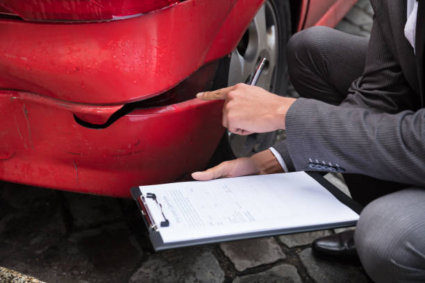 istock Insurance Agent Writing On Clipboard After Car Accident 917885164