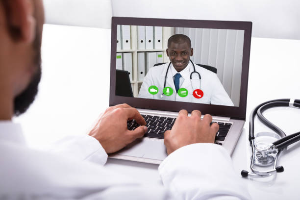 istock Doctor Video Conferencing With Colleague On Laptop 917885434