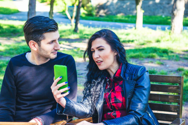 istock Man and woman outdoor using mobile phone. 917885588