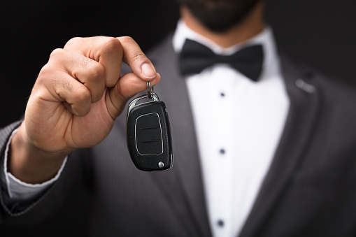 Close-up Of A Waiter's Hand Holding Car Key