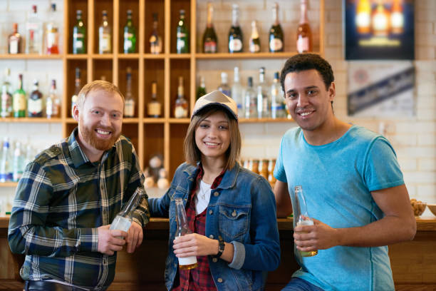 istock Happy friends gathering together in bar 917888938