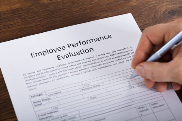 istock Person Filling A Performance Evaluation Form 917891890
