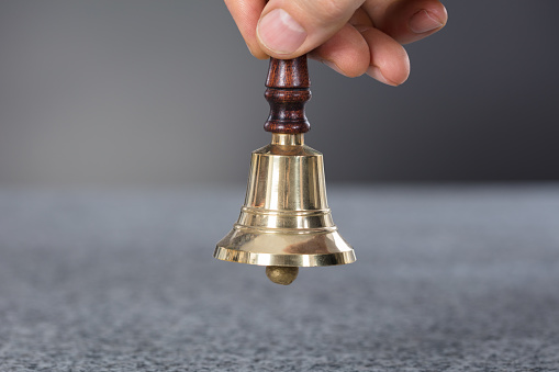 Close-up Of A Person Hand Holding A Ring Bell
