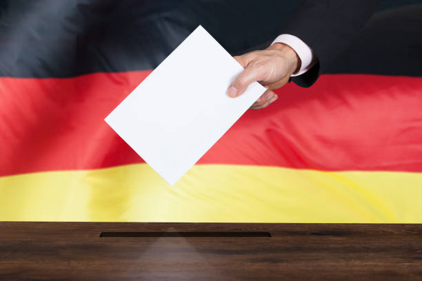 istock Person Putting Vote In A Ballot Box 917891970