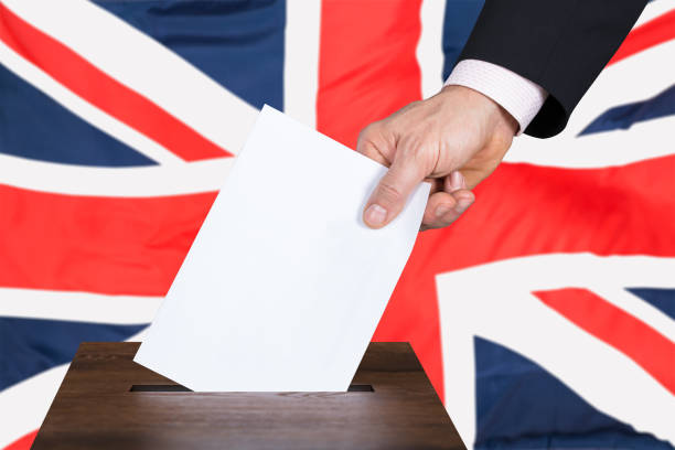 istock Businessperson Putting Vote Into Ballot Box 917891978