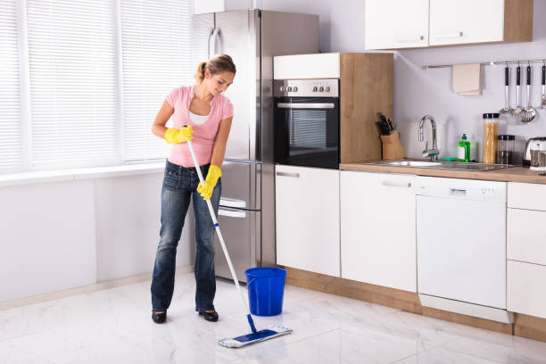 istock Young Woman Cleaning Kitchen Floor With Mop 917892658