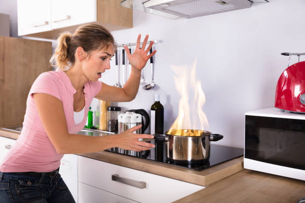 istock Shocked Young Woman Looking At Cooking Pot On Fire 917892702