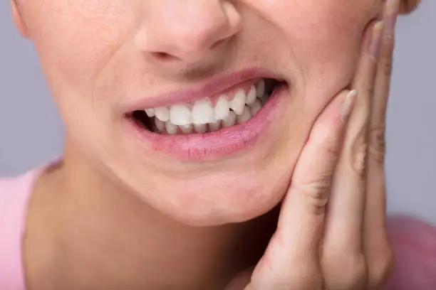Close-up Of Young Woman Suffering From Toothache At Home