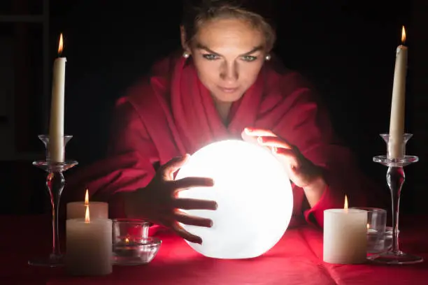 Beautiful Young Fortuneteller Holding Hands Around A Glowing Ball