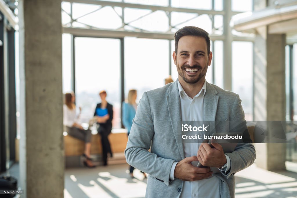 Confident young businemanss Confident young businessman holding a tablet in the office. Men Stock Photo