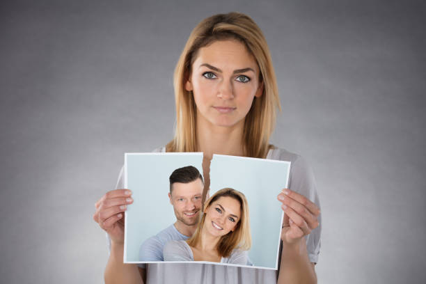 istock Woman Holding Torn Photo 917895792