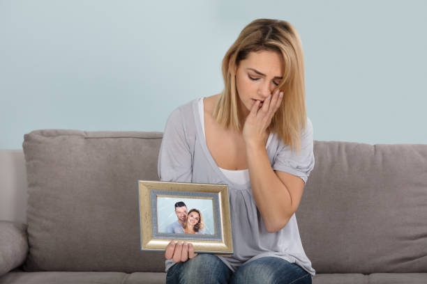 istock Unhappy Woman Holding Picture Frame 917895818