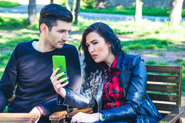 istock Man and woman outdoor using mobile phone. 917895822
