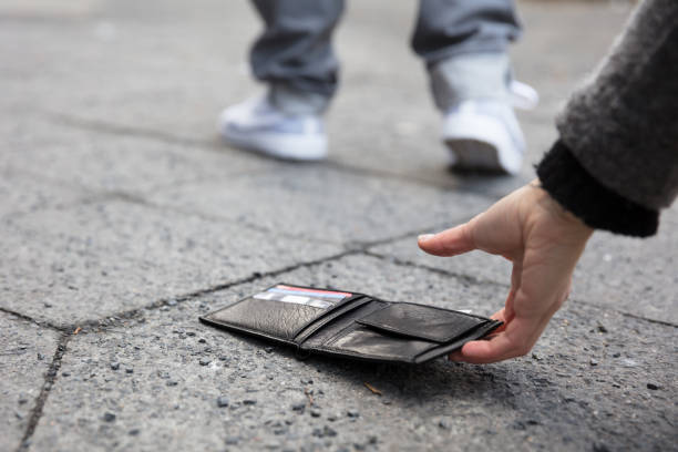 istock Person Picking Up A Lost Wallet 917895902