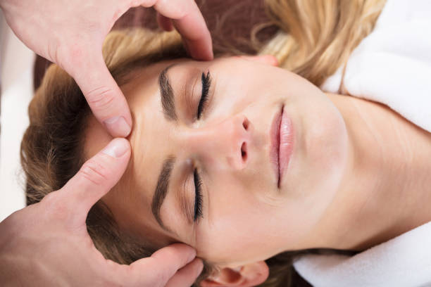 istock Therapist Giving Massage On Woman's Forehead 917895978