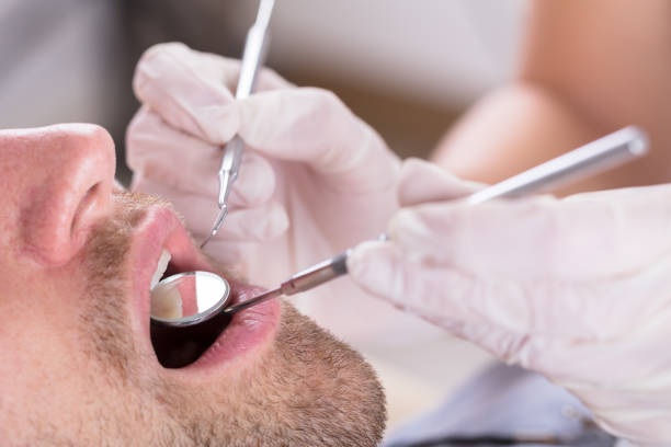 istock Male Patient Examined By Dentist 917896188