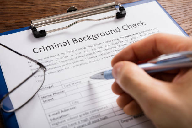 istock Person Filling Criminal Background Check Application Form 917896530