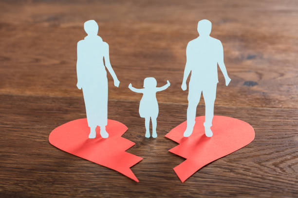 Family Paper Cut On Broken Heart Close-up Of A Family Paper Cut On Broken Heart At Wooden Desk pictures of divorce papers stock pictures, royalty-free photos & images