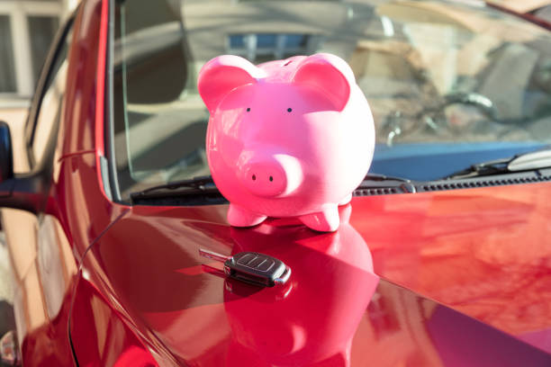 istock Piggybank With Car Key On Car 917899698
