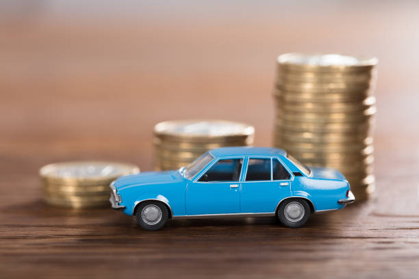 istock Car Model In Front Of Stacked Coin 917899762