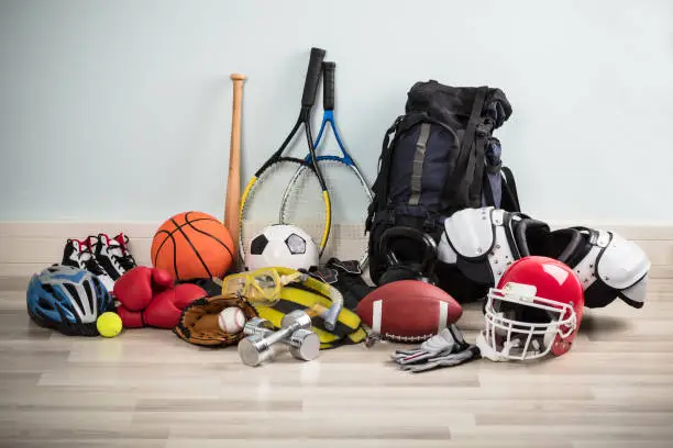 Photo Of Various Sport Equipments On Hardwood Floor