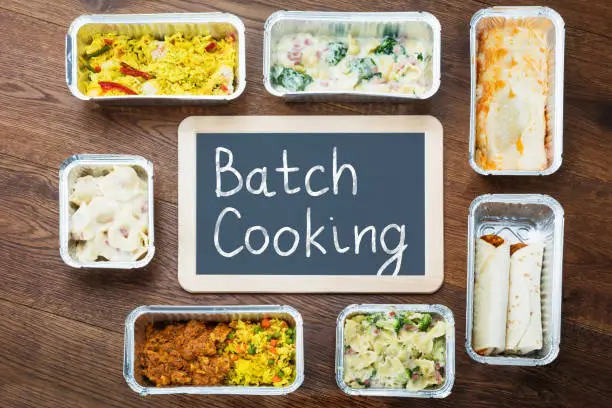 Batch Cooking Text Written On Slate With Take Away Dishes In Foil Container On Table