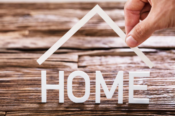 istock Close-up Of A Human Hand And Home Text 917901858