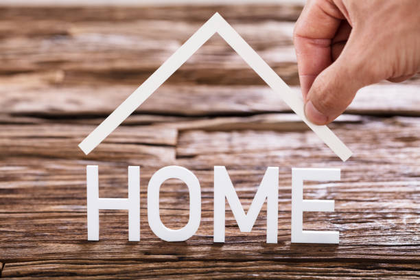 istock Close-up Of A Human Hand And Home Text 917901864