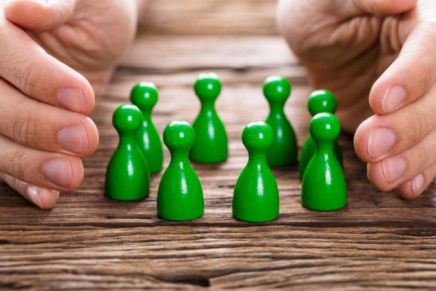 istock Person Protecting Green Persons 917901908