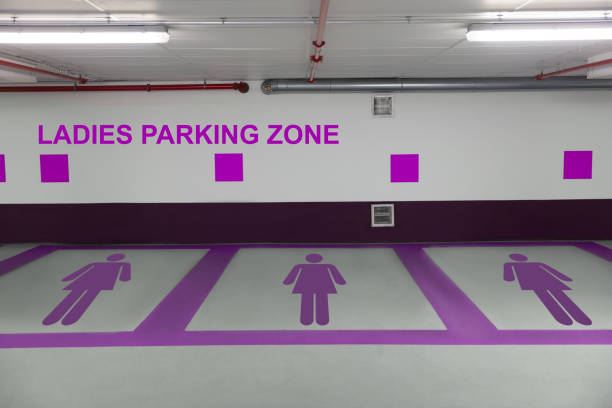 Purple female figures in basement with ladies parking zone sign