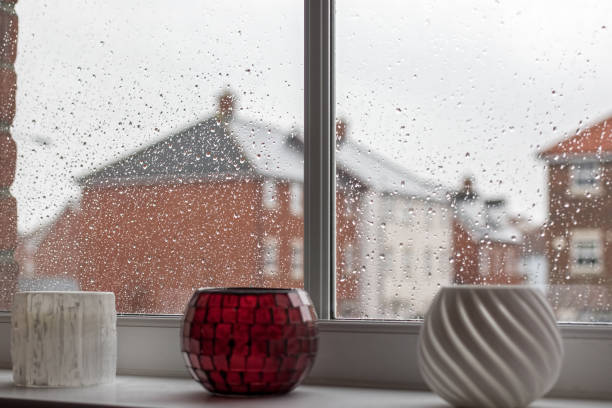 istock Rainy day depression. Raindrops on modern house window glass pane. 917907572