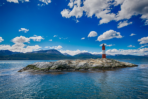 The famous Les Eclaireurs Lighthouse in the Beagle Channel, Ushuaia, Tierra del Fuego. On the small island there is a colony of rock shags (Magellanic cormorant).