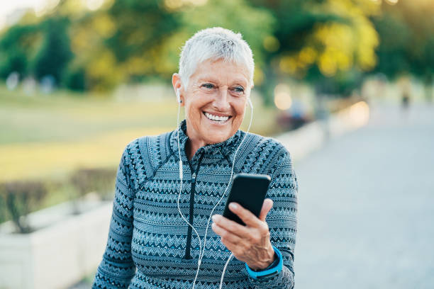 istock Senior sportswoman with mobile phone 917915700