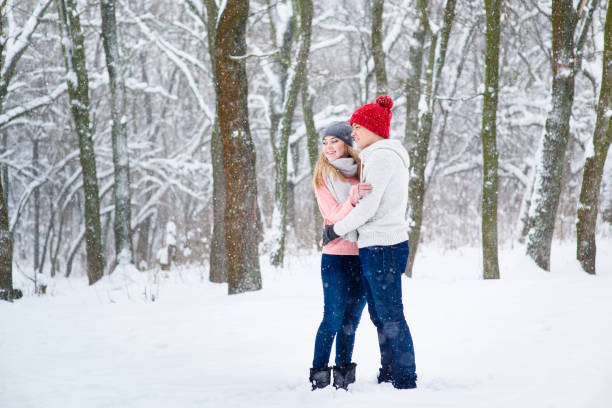 istock Young couple in winter forest 917918682