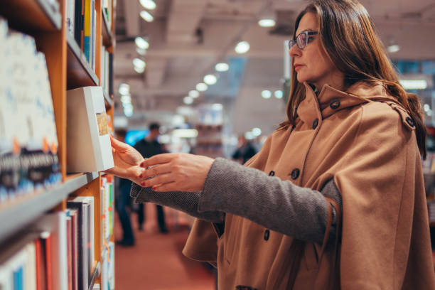 istock Woman searching for new book 917918956