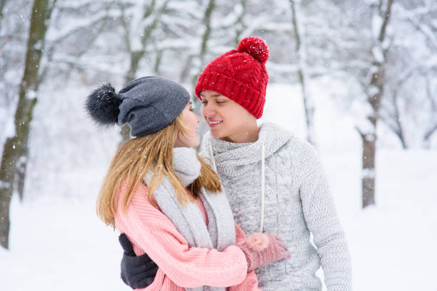istock Couple in love looking at each other during snowfall 917918978