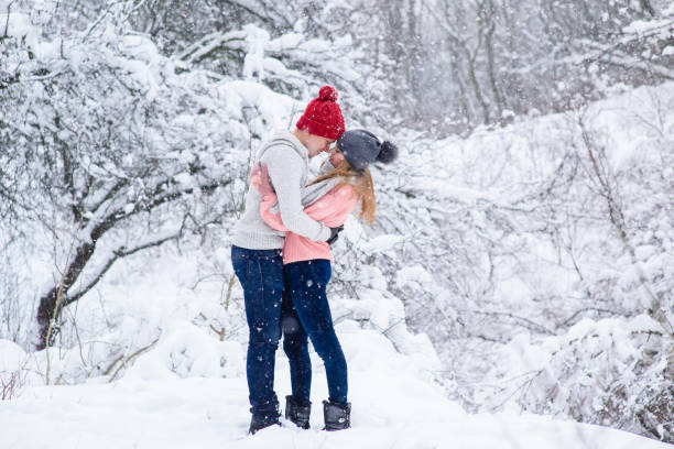 istock Couple in knitted hats going to kiss 917919620