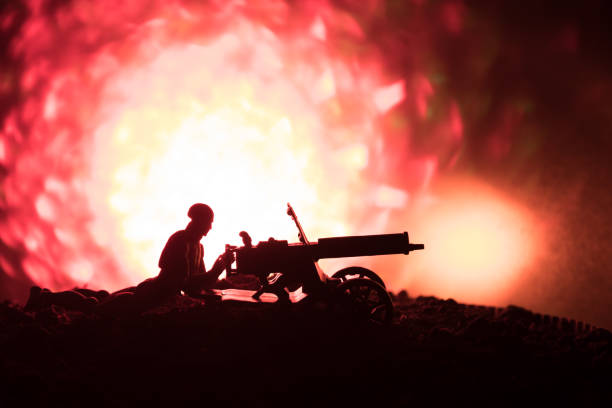 istock Man with Machine gun at night, fire explosion background or Military silhouettes fighting scene on war fog sky background, World War Soldiers Silhouettes Below Cloudy Skyline At night. 917923478
